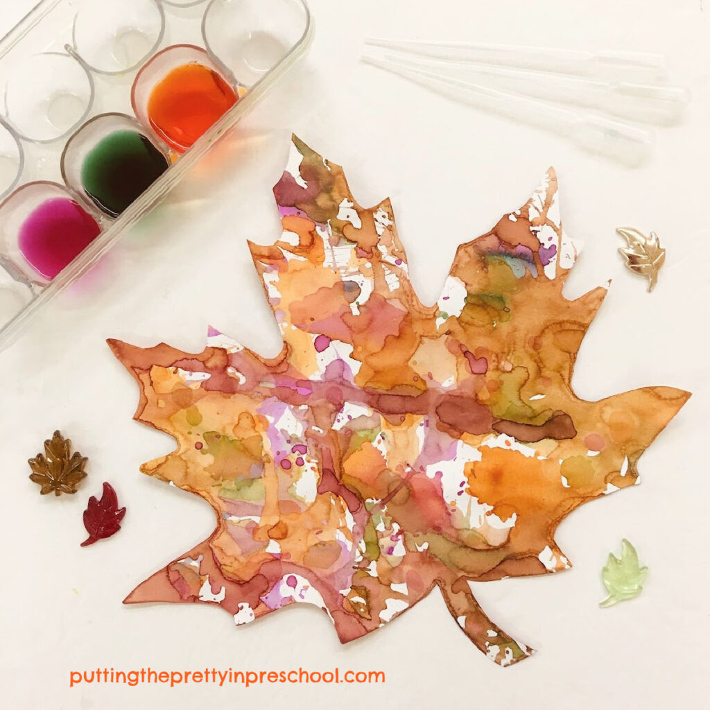 A blow dryer painting technique yields beautiful results on a maple leaf cut out.