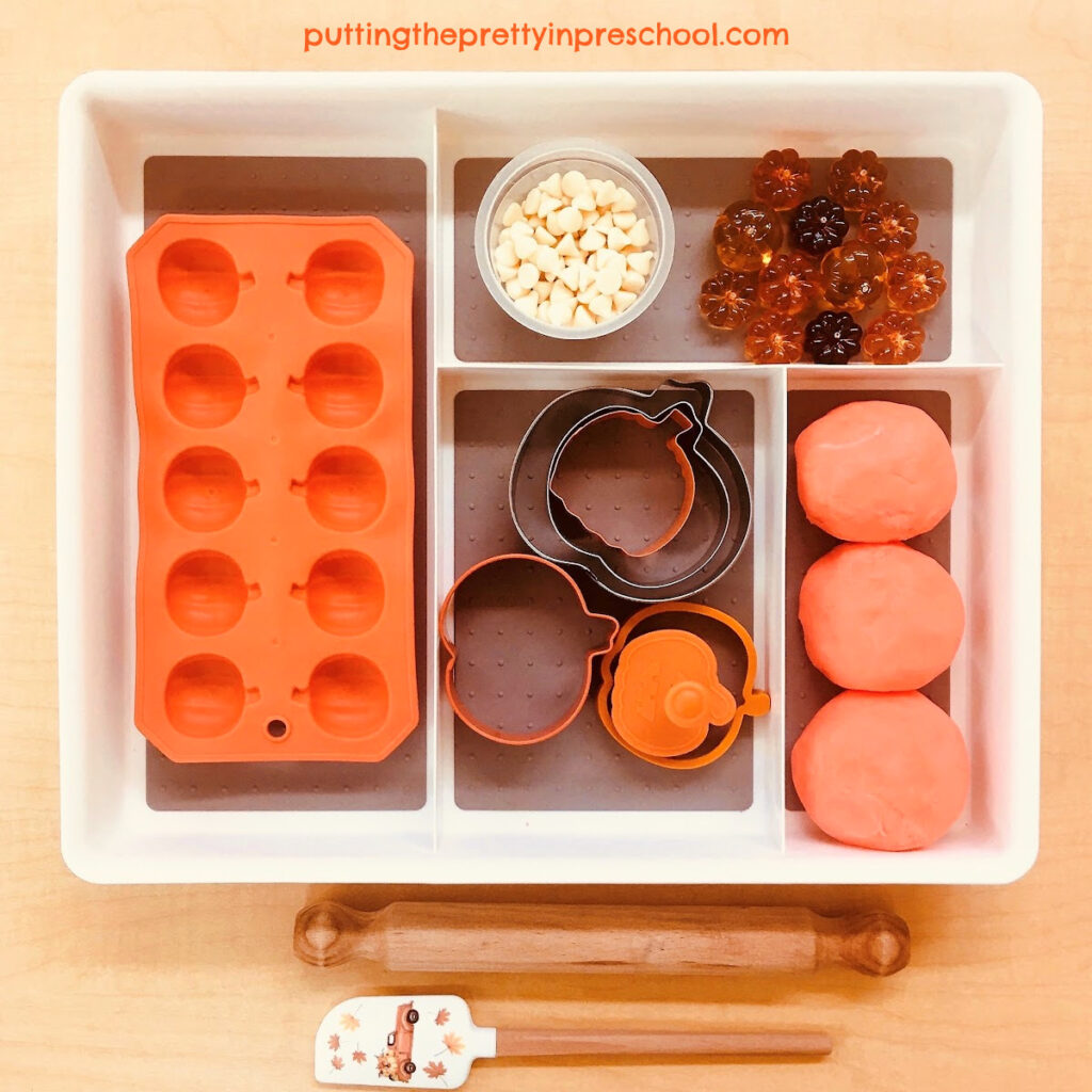 A warty pumpkin-themed playdough tray with taste-safe, edible dough.