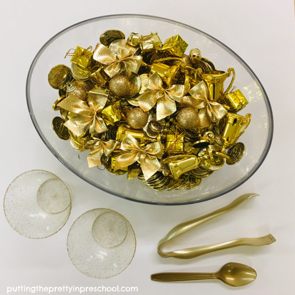 A rich New Year's all gold sensory activity featuring shiny metallic loose parts for little learners to explore.