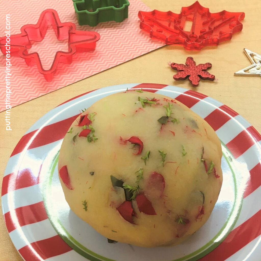 Lemon cypress scented playdough with cut silk poinsettia leaves and bracts.