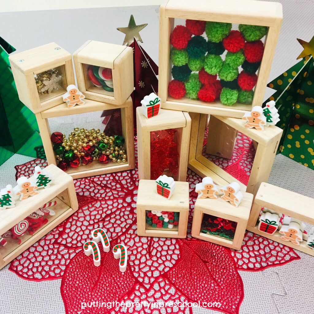Christmas erasers and foil trees add interest to a Christmas treasure block play invitation.