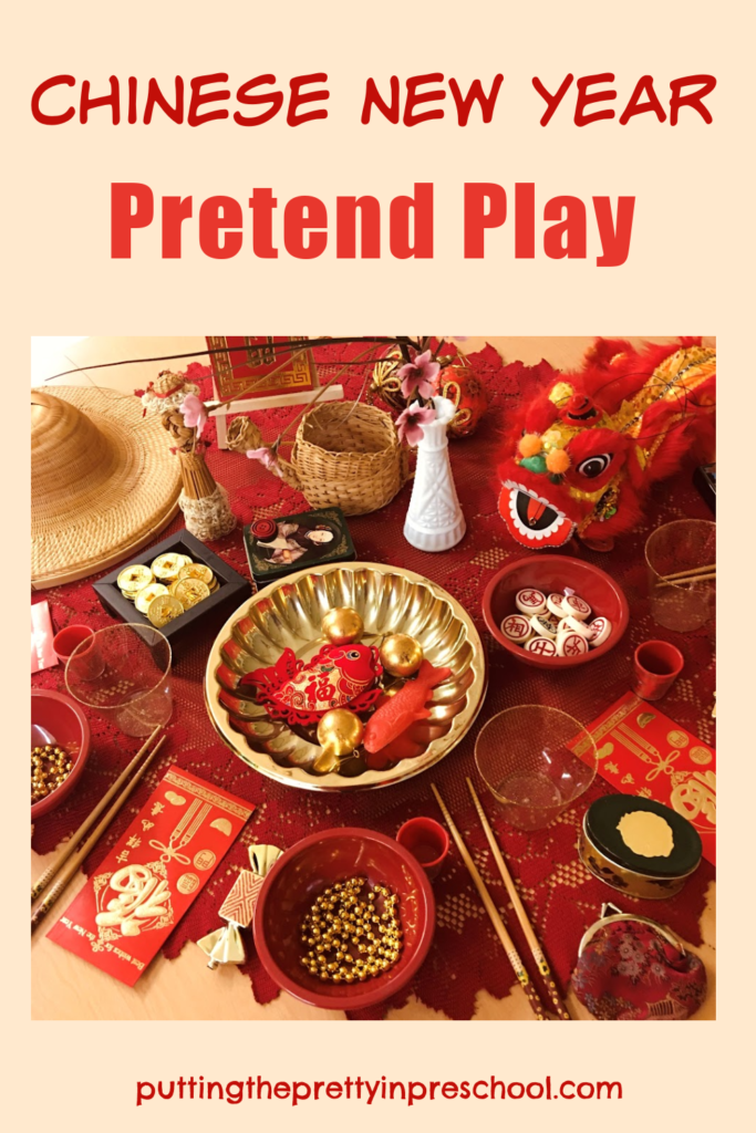 Little learners will love to explore this Chinese New Year tablescape set up filled with Asian artifacts and red and gold loose parts.