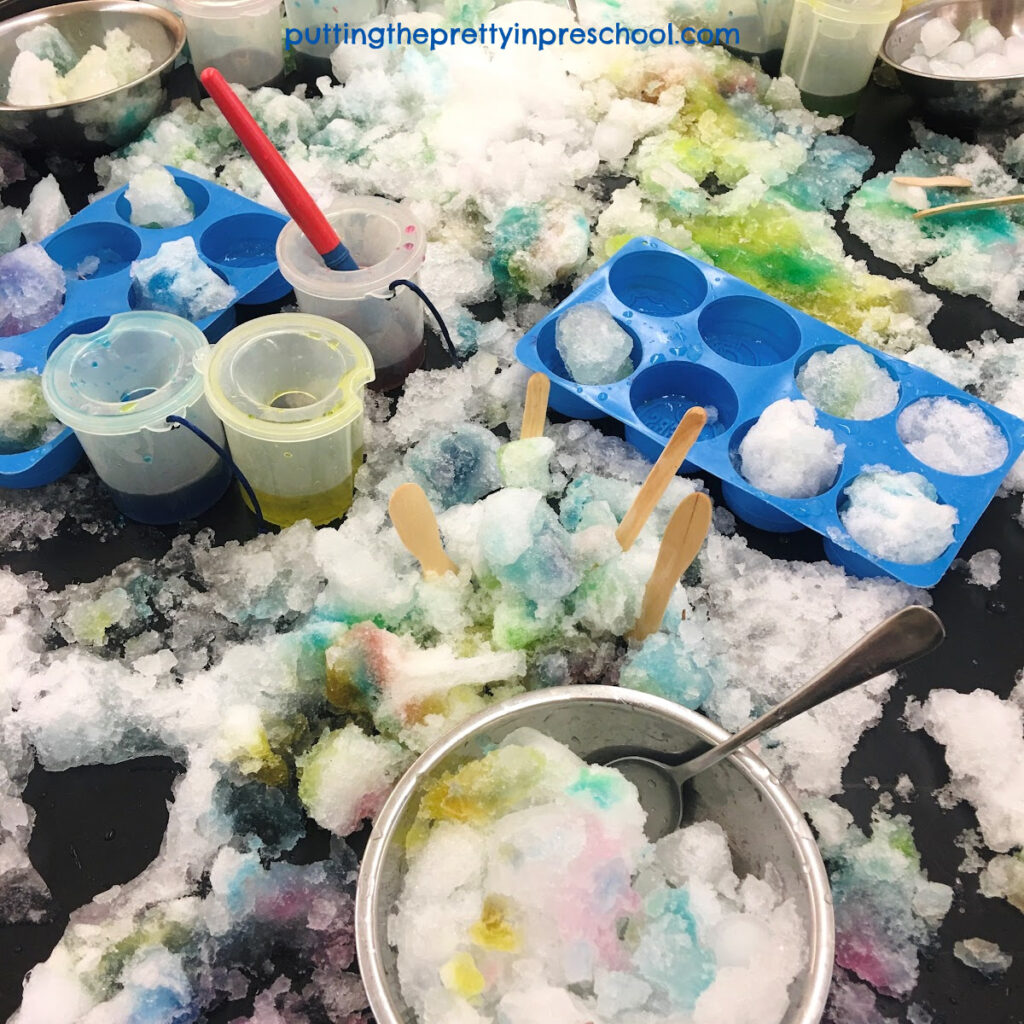 Kitchen accessories add to the play experience in this snow painting sensory table activity.