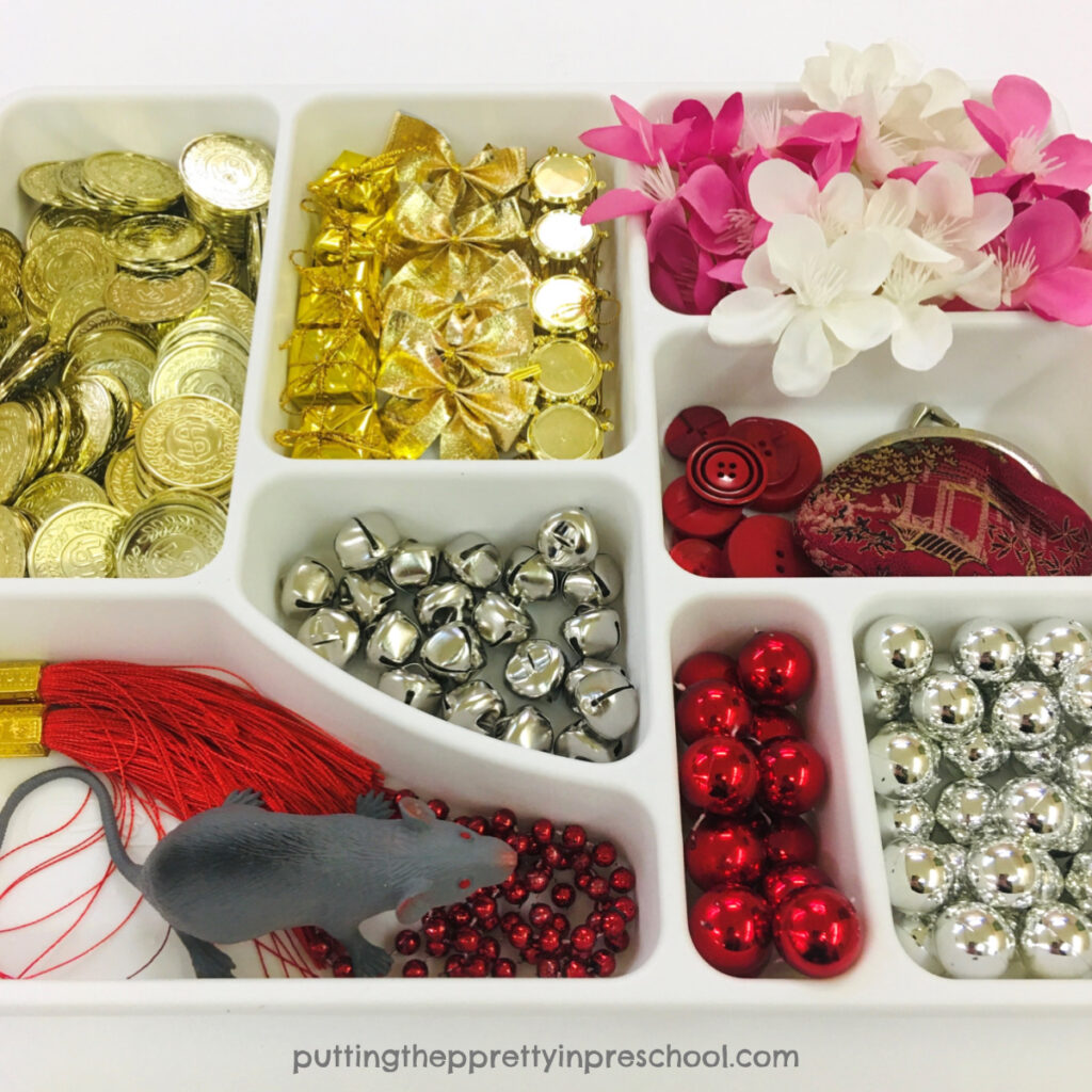 Loose parts for a Chinese New Year noodle bin with a "year of the rat" theme.