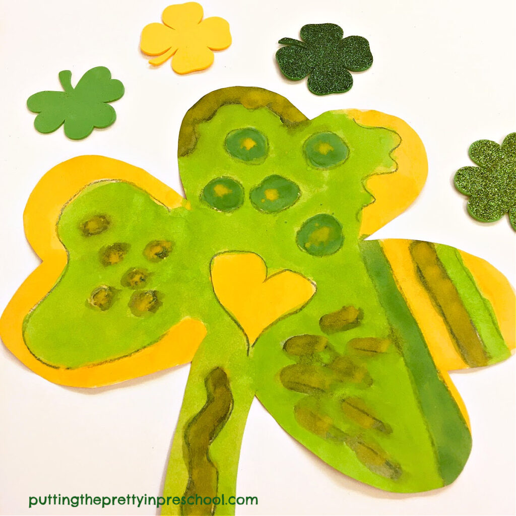 Offer this simple crayon resist watercolor shamrock activity that explores variety in line, shape, and color.