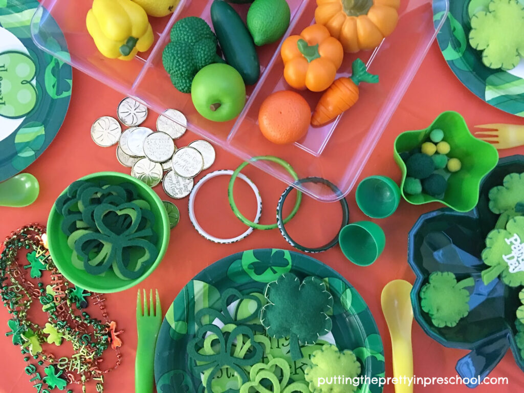 Set up this inviting St. Patrick's Day tablescape that is filled with green, yellow, and orange loose parts to spark creative, imaginative play.
