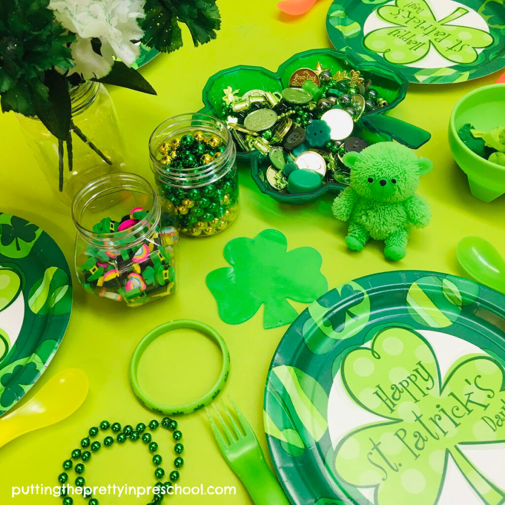 Set up this cheery St. Patrick's Day tablescape that is filled with green and gold loose parts and plenty of shamrocks.