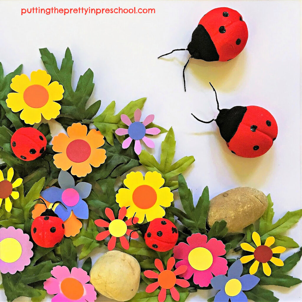 A color-filled ladybug and flower sensory tray. Facts about ladybugs and blooms included.