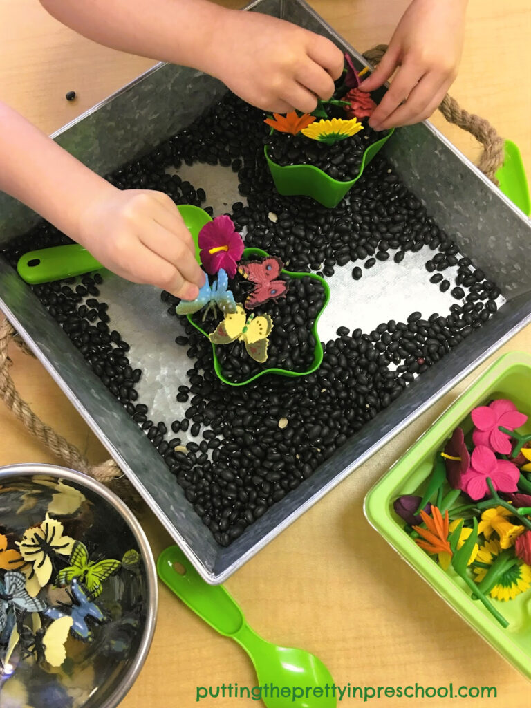 Miniature flower and butterfly figurines take center stage in this easy-to-set-up flower planting sensory activity.