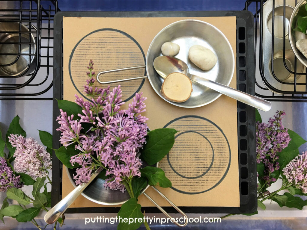 This DIY mud kitchen is a must-try. Aromatic lilac flowers accentuate the nature-based play invitation.