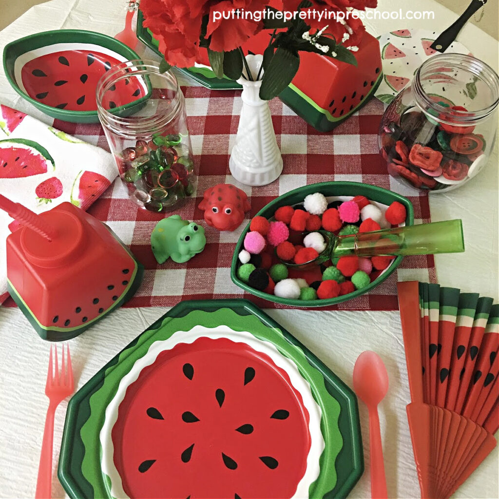 Watermelon-themed picnic tableware and loose parts add a welcome burst of color to a dramatic play center.