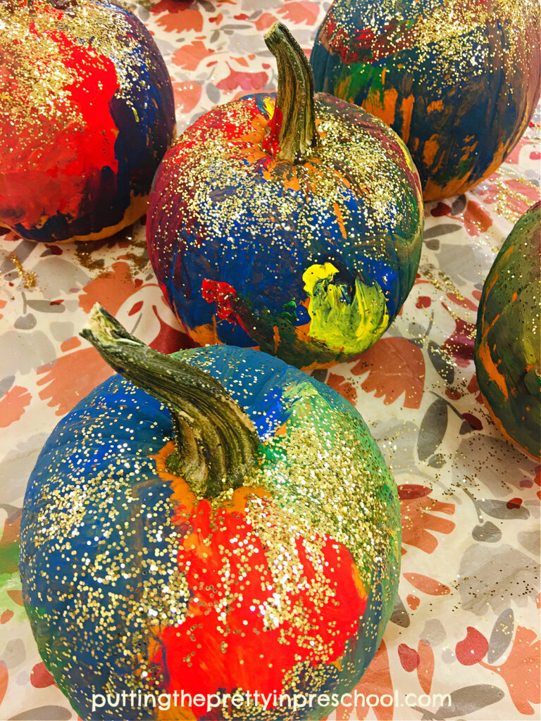 Gold glitter glams up painted pumpkins big time, and is a welcome addition to this showy process art activity.