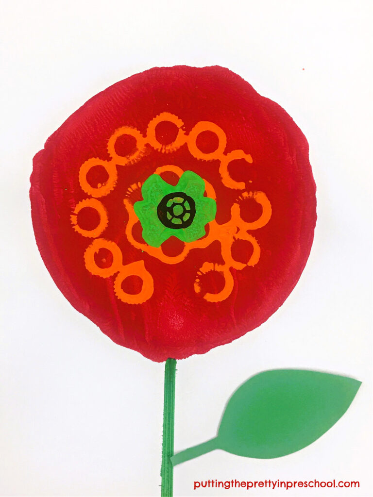 Bubble wand, sponge bottle brush, and spool paint prints add color and definition to this gadget printmaking poppy art project.