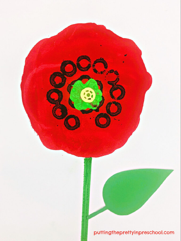 Bubble wand, sponge bottle brush, and spool paint prints add color and definition to this gadget printmaking poppy art project.