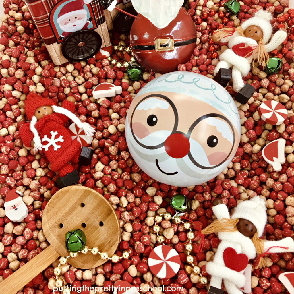 A fillable Santa Claus ornament and other dollar store supplies make for an inviting chickpea-based sensory bin.