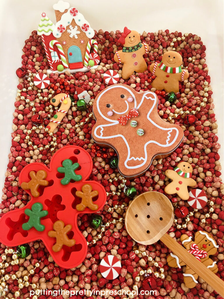 An easy-to-put-together gingerbread sensory bin with a chickpea base. An economical bin with dollar store gingerbread accessories.