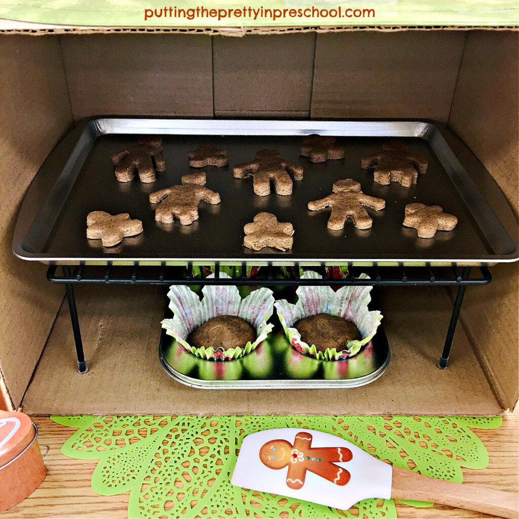 A cardboard box with a rack set inside makes a terrific play oven to bake gingerbread playdough cookies and muffins.
