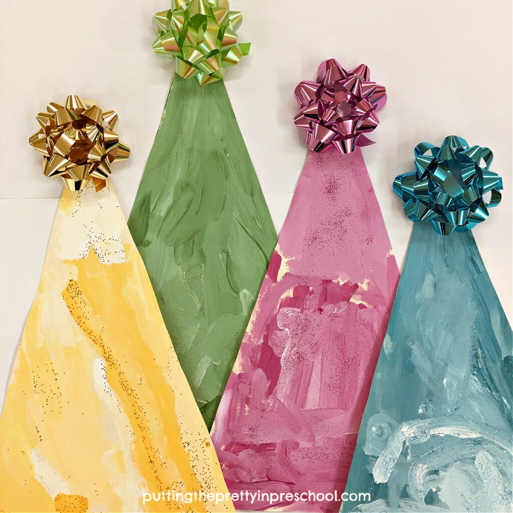 This monochromatic Christmas tree art project is done in pastel shades of green, yellow, teal, and magenta. The trees look beautiful on display.
