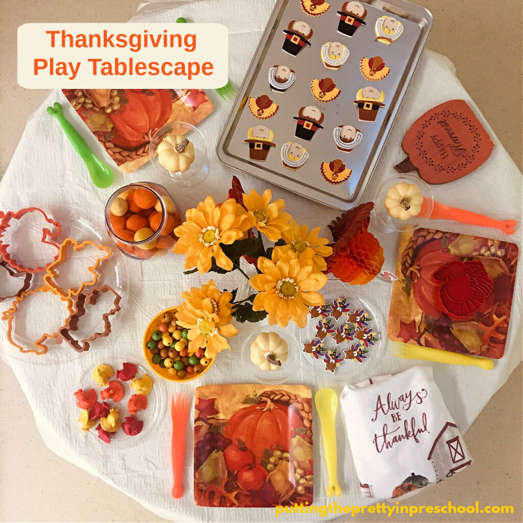 Turkey-themed loose parts are the highlight of this Thanksgiving play tablescape setup.