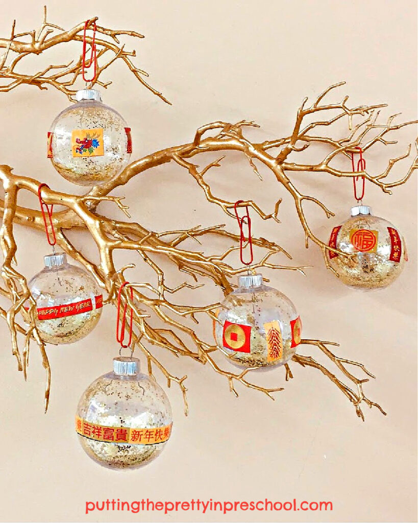 Make these sparkly Chinese New Year-themed ball ornaments using gold glitter and themed stickers.