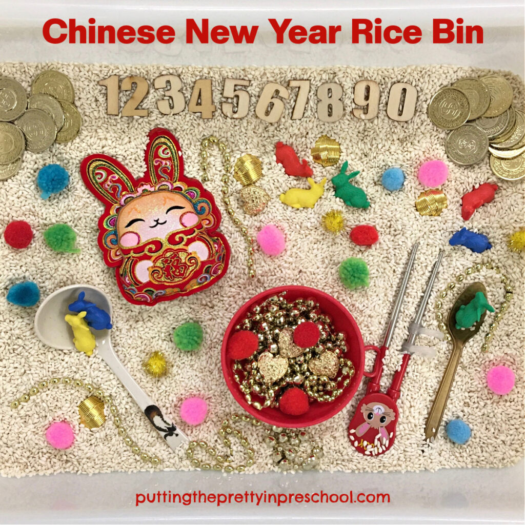A stuffed bunny decoration and rabbit counters are highlights in this Year of The Rabbit Chinese New Year rice bin.