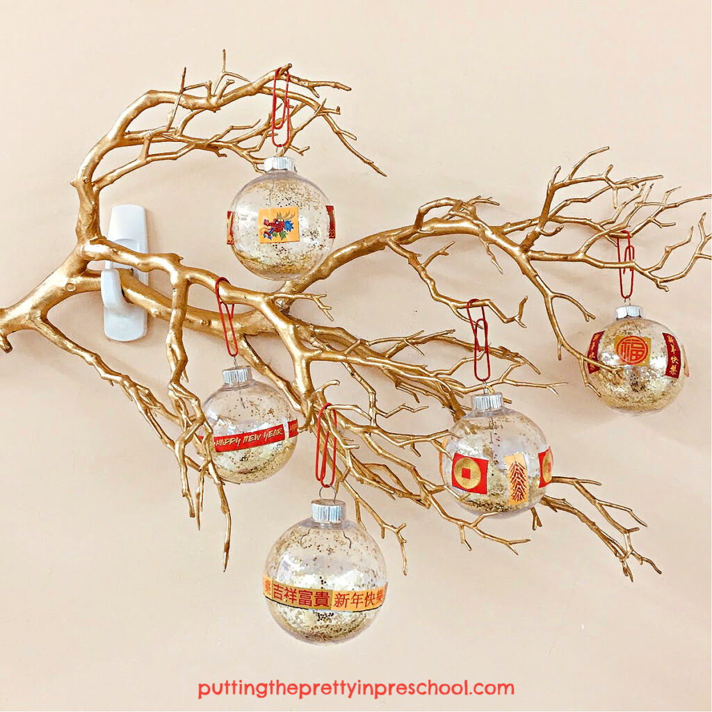 Make these sparkly Chinese New Year-themed ball ornaments using gold glitter and themed stickers.