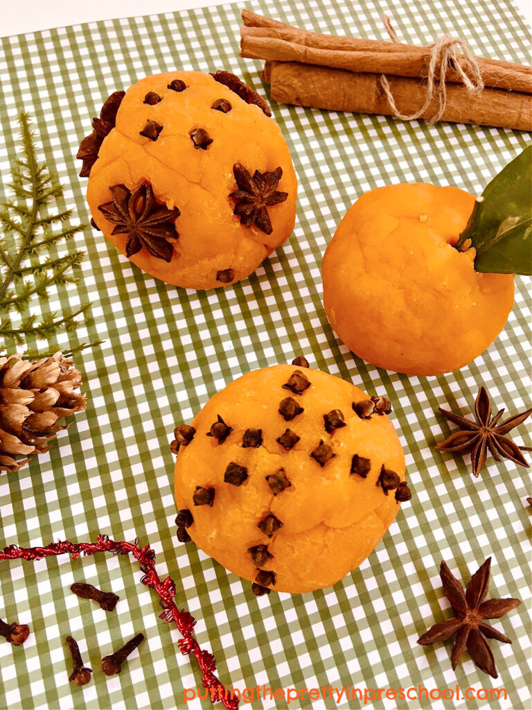 Cinnamon sticks, cloves, and star anise add fun to an orange-scented playdough invitation.