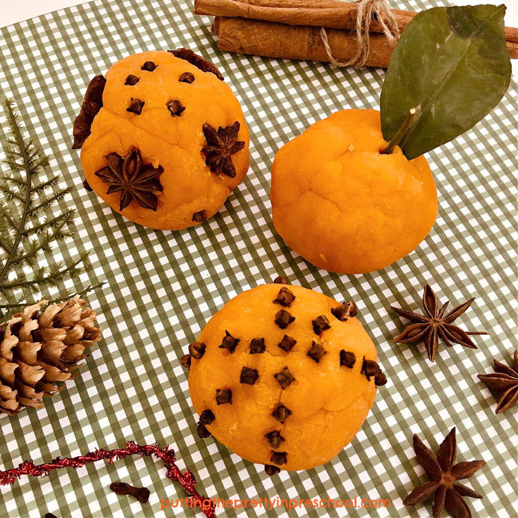 Cinnamon sticks, cloves, and star anise add fun to orange-scented playdough creations.