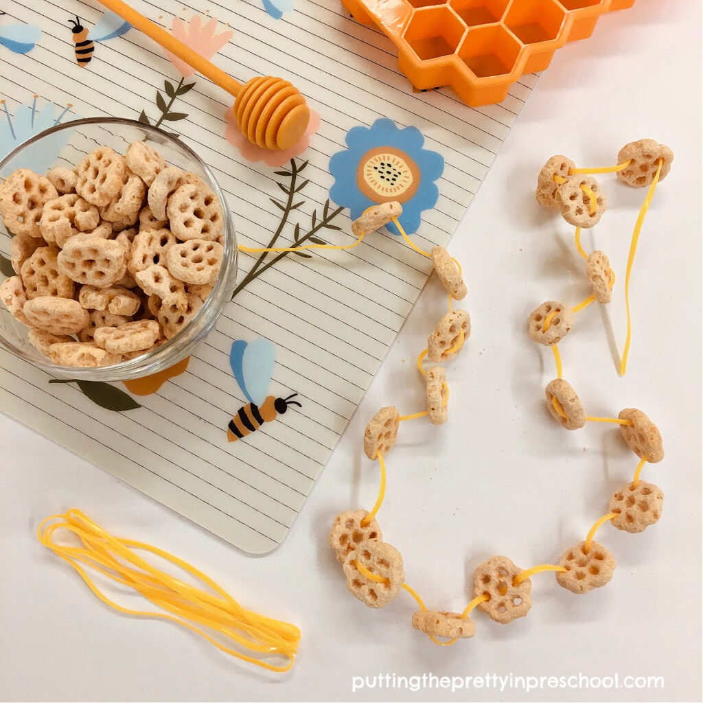 A fun bee theme honeycomb cereal necklace lacing activity that is great for fine motor control and eye-hand coordination practice.