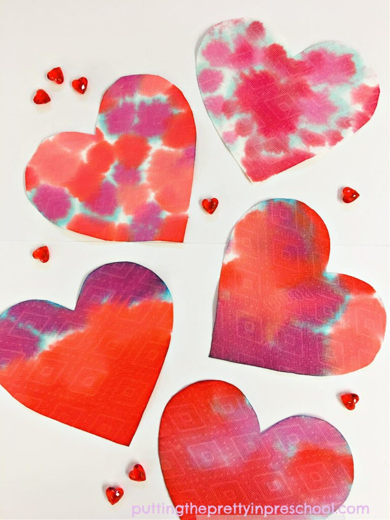 A fabulous eye dropper painting process art activity with food coloring paint and paper towel hearts.