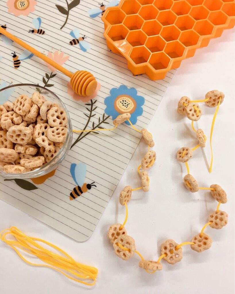 A fun honeycomb cereal necklace lacing activity that is great for fine motor control and eye-hand coordination practice. An all-ages craft