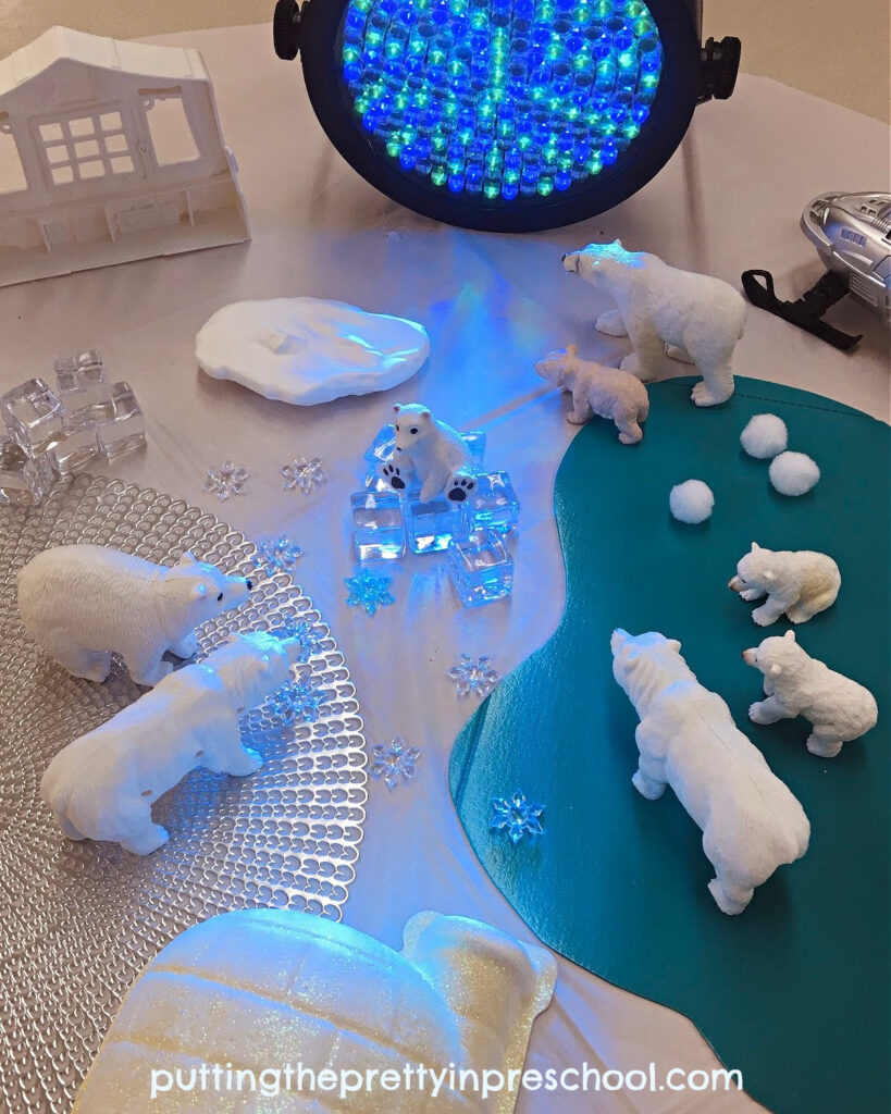 A professional stage light adds interest to this northern lights-inspired polar bear small world.