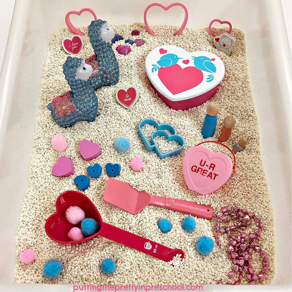 A cute Valentine's Day rice sensory bin inspired by llamas. There are lots of fun loose parts to explore in the bin.