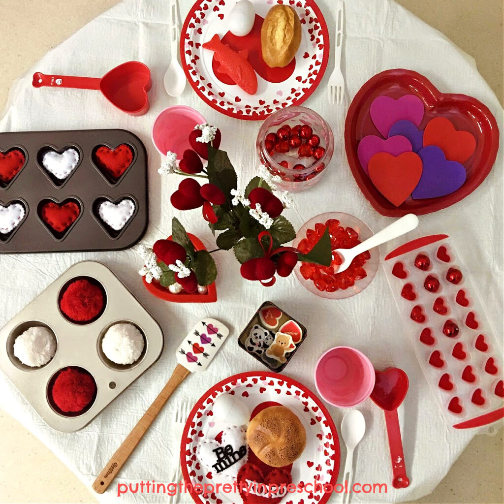 Lots of hearts and red and white loose parts make this Valentine's Day pretend play tablescape fun to play in.