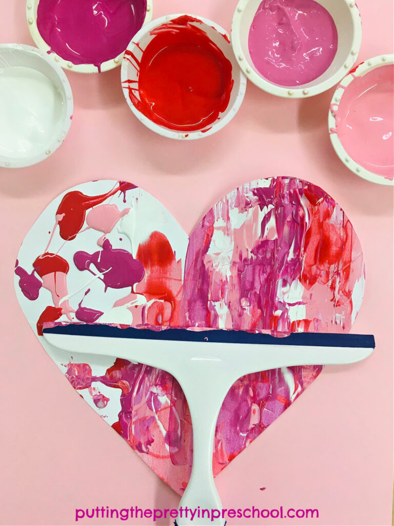 How to paint with a squeegee to create beautiful heart art. This is an all-ages process art activity with collaborative possibilities.