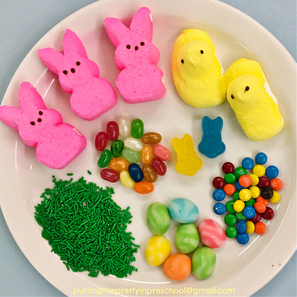 Easter peeps and an assortment of candy to make graham cracker Easter peeps houses.