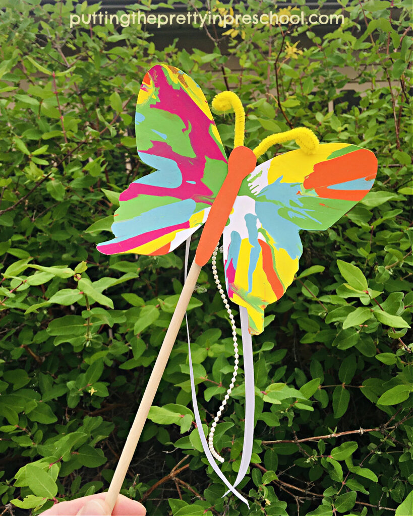 Beautiful spin painitng butterfly wand craft your little learners will love. An all-ages process art project.