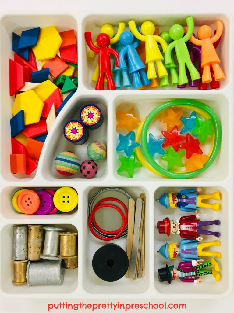 Bright and cheery circus-themed loose parts tray for playdough or small world play.