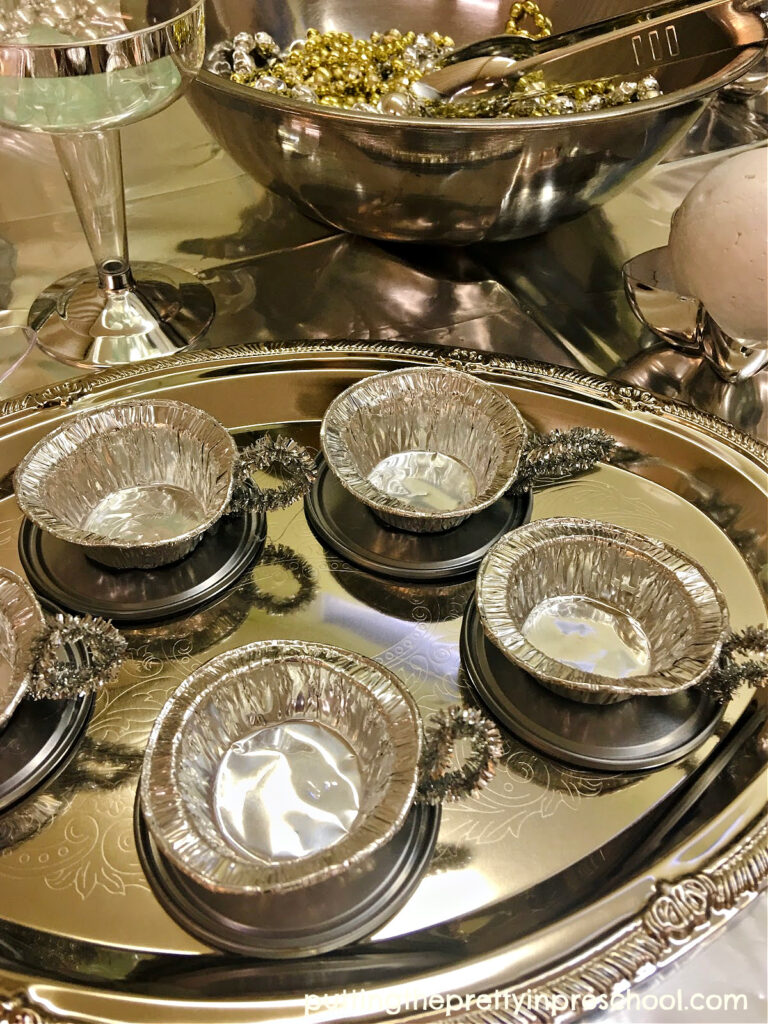 DIY metallic silver tea cups created for an outer space pretend play tablescape for little learners.