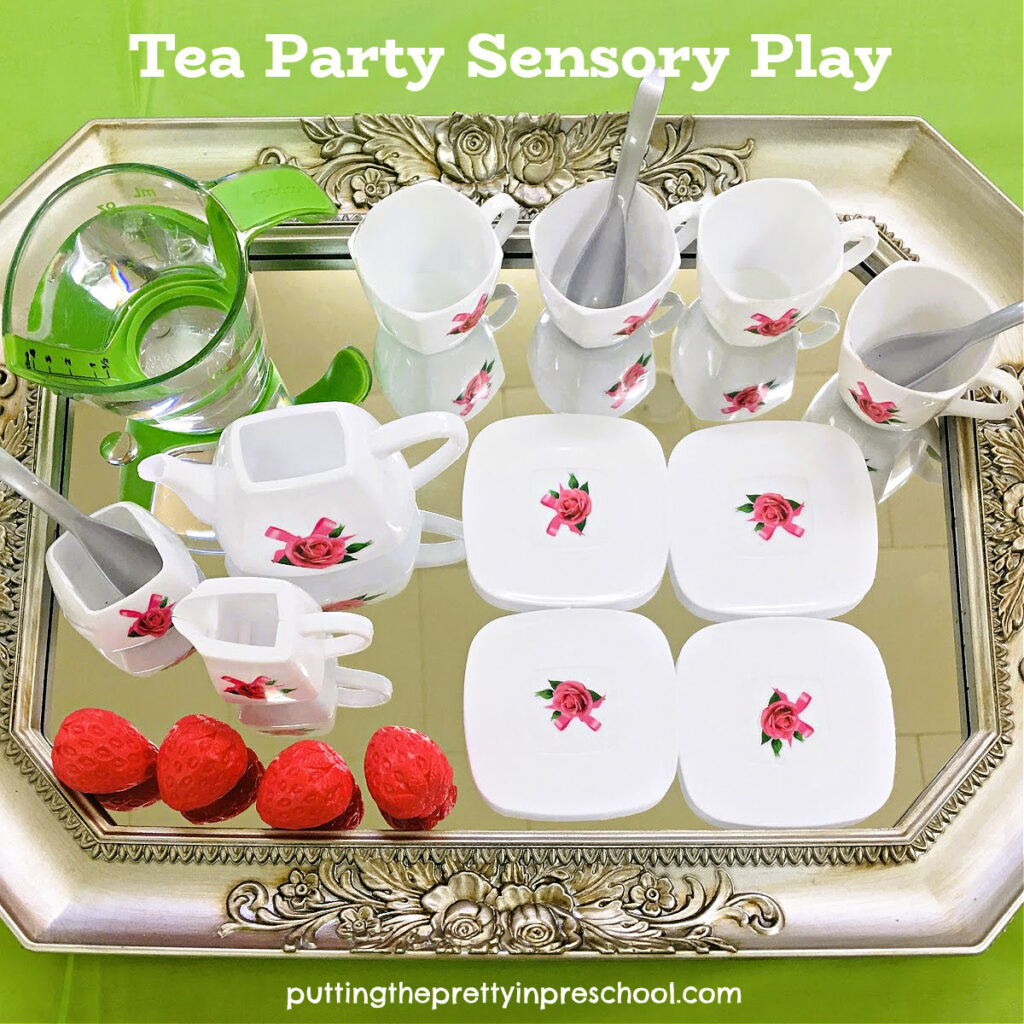 This silver-edged, gilded mirror tray is paired with a dainty miniature tea set for super inviting tea party water play.