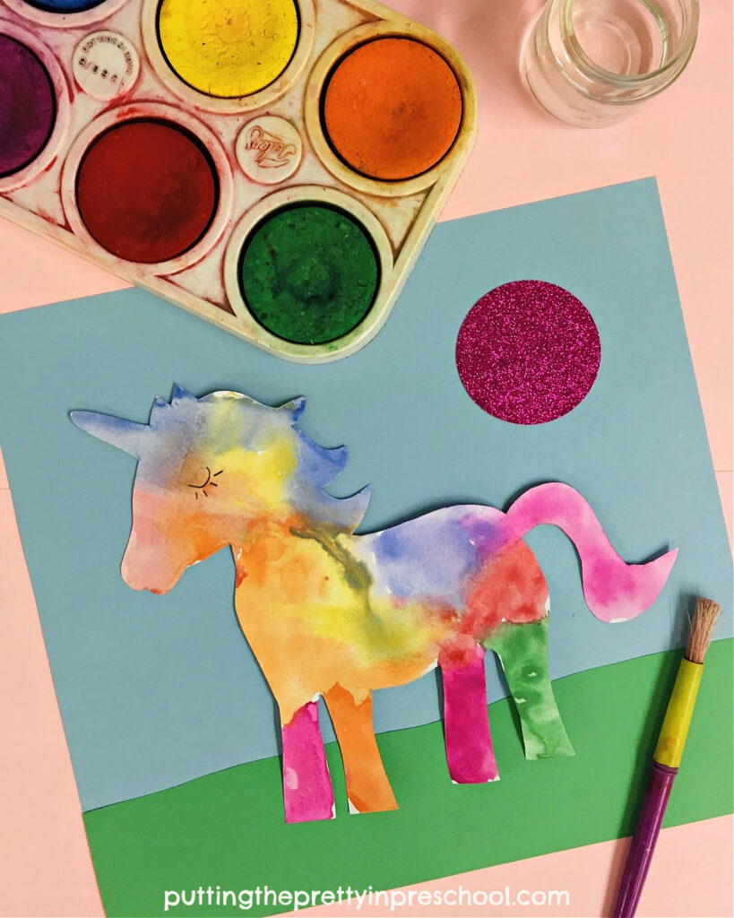 Beautiful unicorn watercolor art project with non-toxic tempera paint pucks and fadeless construction paper. Free unicorn printable to download.
