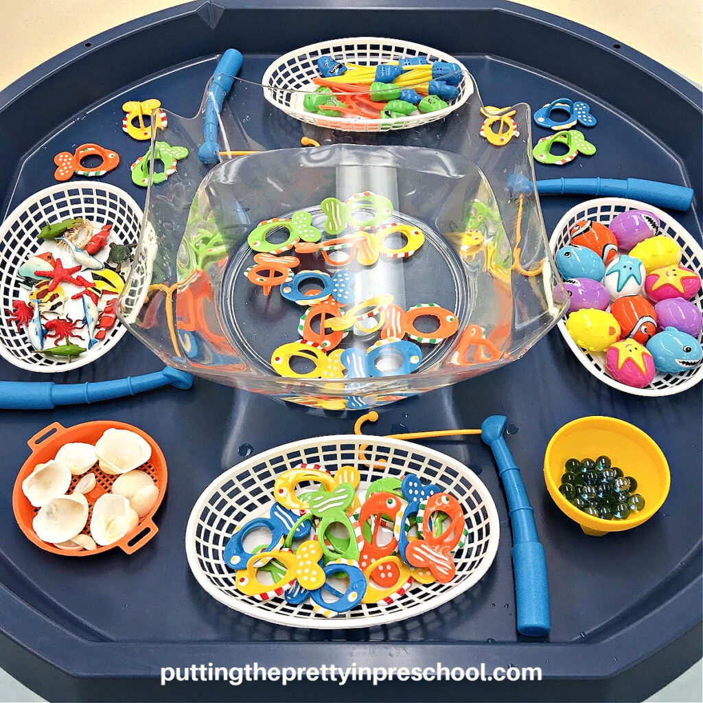 Use toy fishing rods and accessories for a super fun "Go Fishing" active world tray. Add ocean-themed loose parts to extend play.