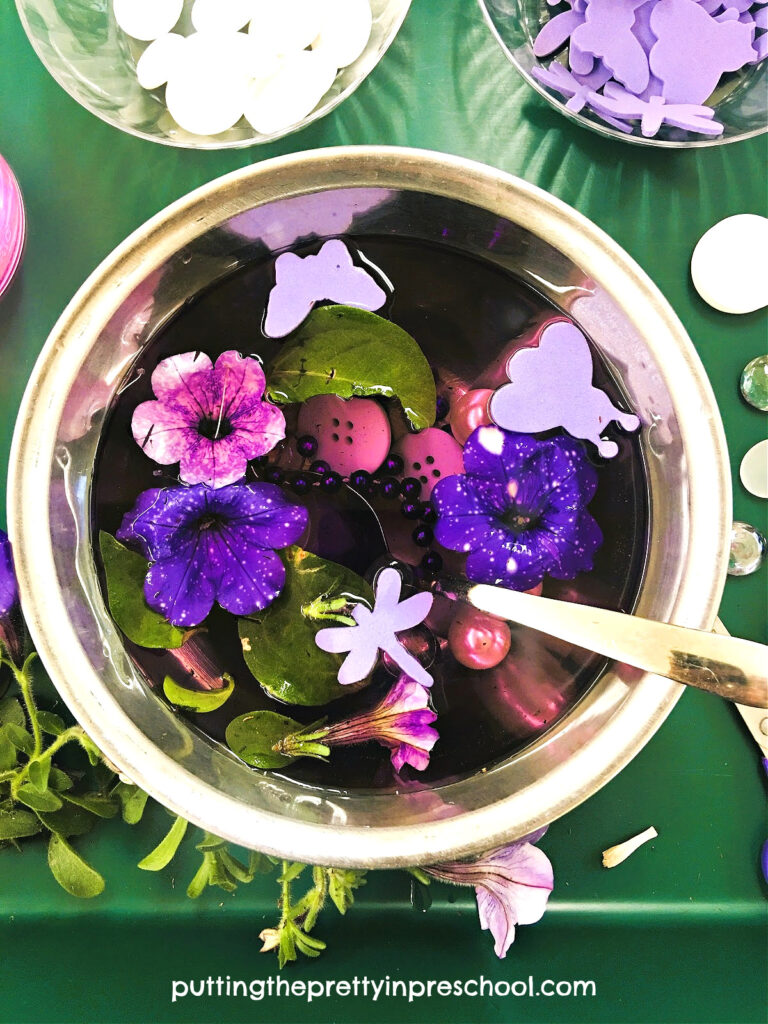 Oh-so-fun sensory play with petunia flowers and pretty purple and white loose parts. A nature-based sensory activity.
