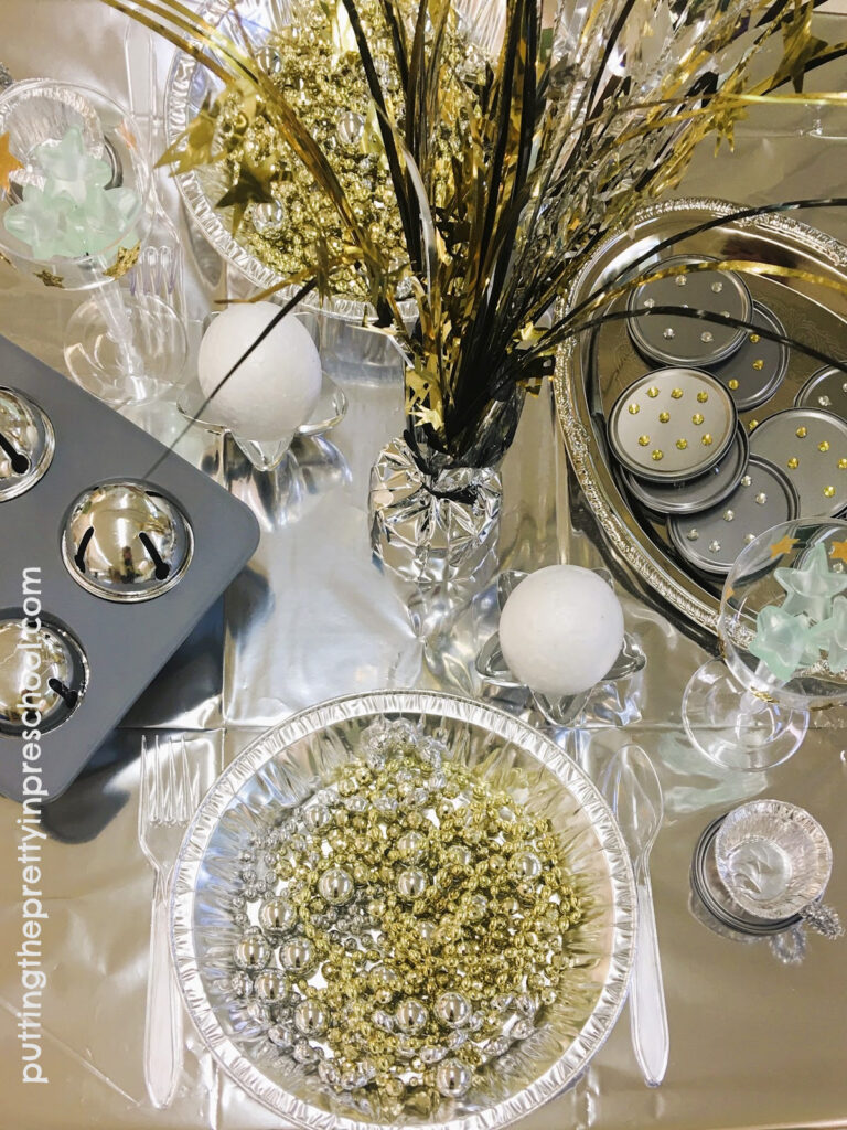 Metallic silver and gold loose parts make great play food for a space restaurtant dramatic play center.