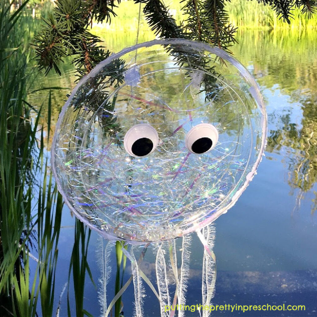 Make this sparkly iridescent jellyfish craft that doubles as an ocean drum and movement prop, It displays beautifully indoors or outdoors.