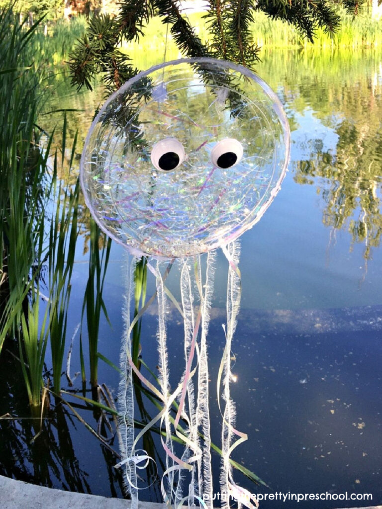 Make this sparkly iridescent jellyfish craft that doubles as an ocean drum and movement prop, It displays beautifully indoors or outdoors.