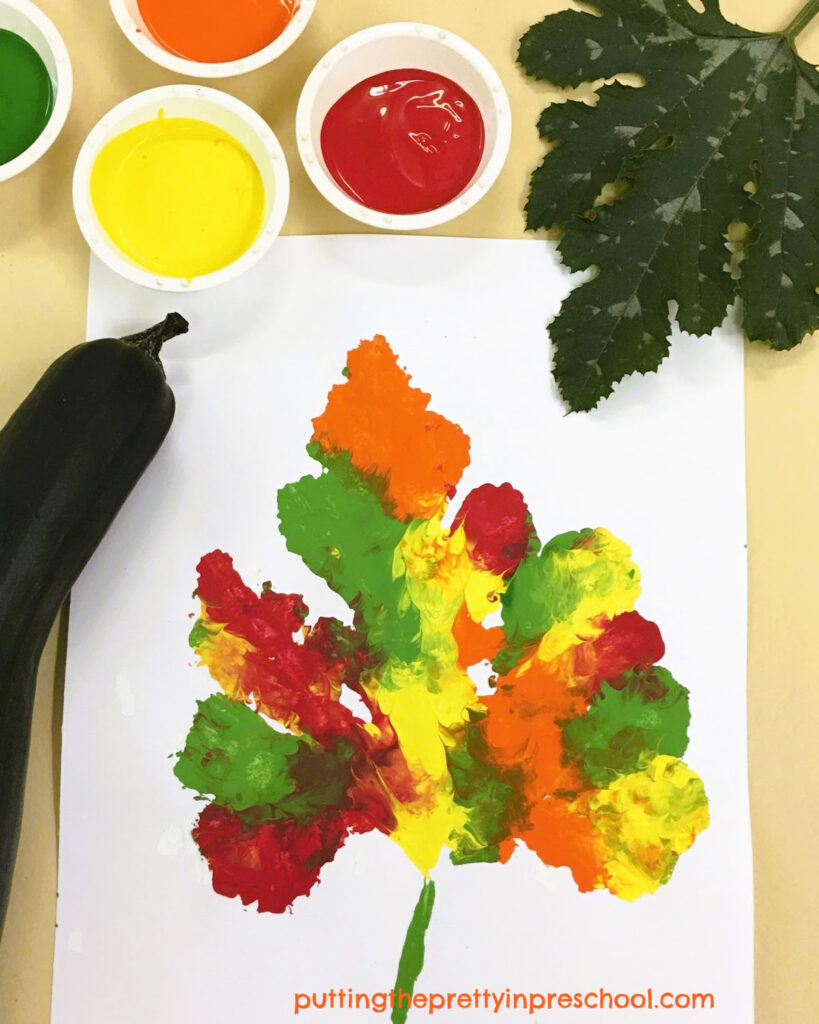 A leaf print in fall colors made with a large zucchini leaf and tempera paint. An all-ages art activity everyone will enjoy.