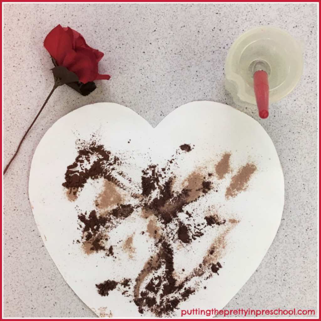 Painting with cocoa and hot chocolate powder. The powders are moved around with a paintbrush dipped in water.
