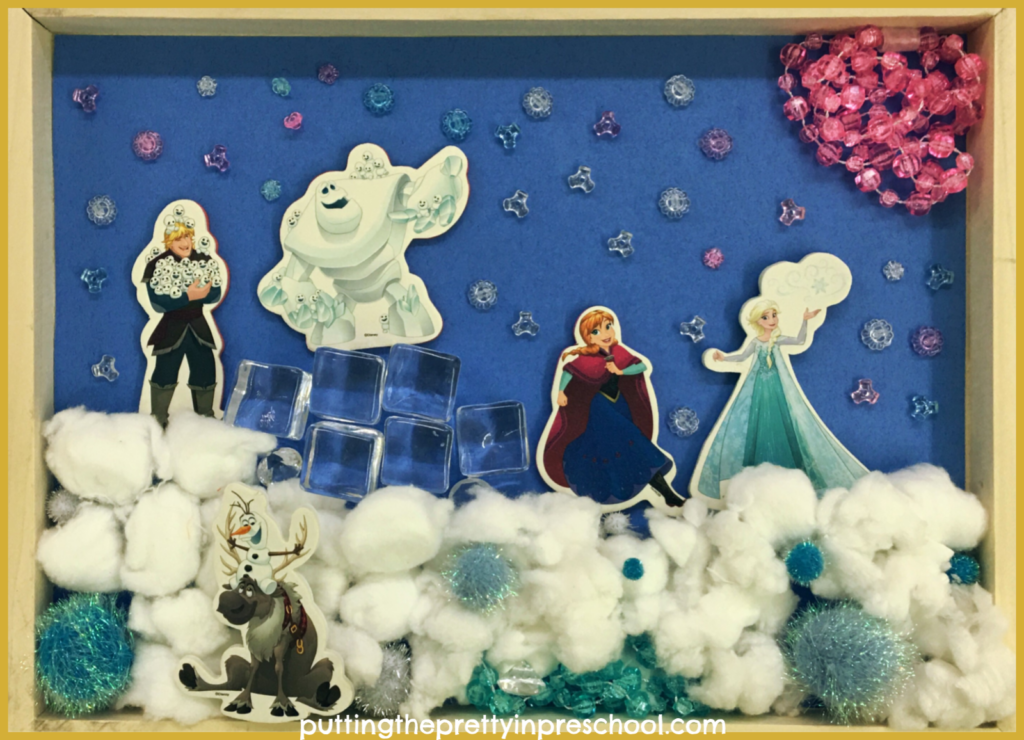 Frozen inspired shadow box. Invitation for children to create a scene with Frozen bathtub stickers and loose parts. An all-ages activity.