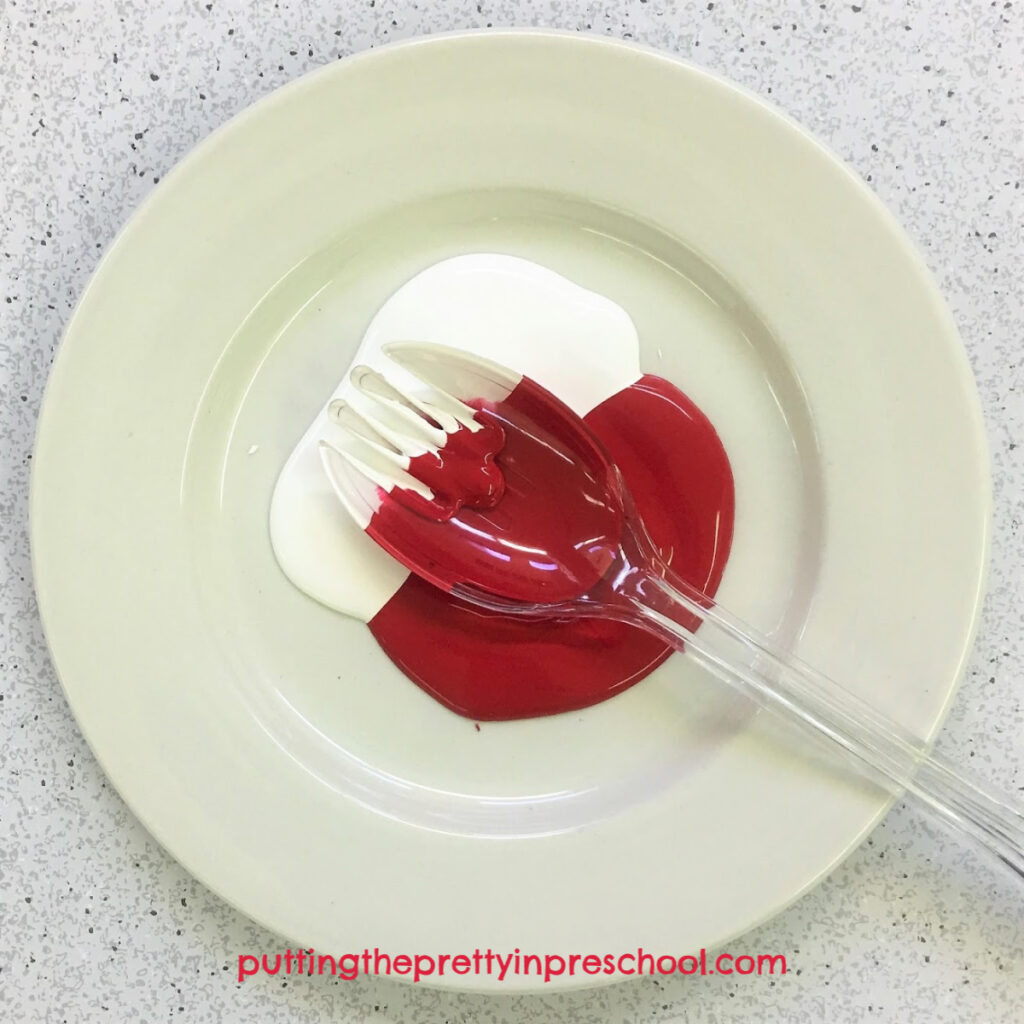 Salad fork dipped in red and white paint.